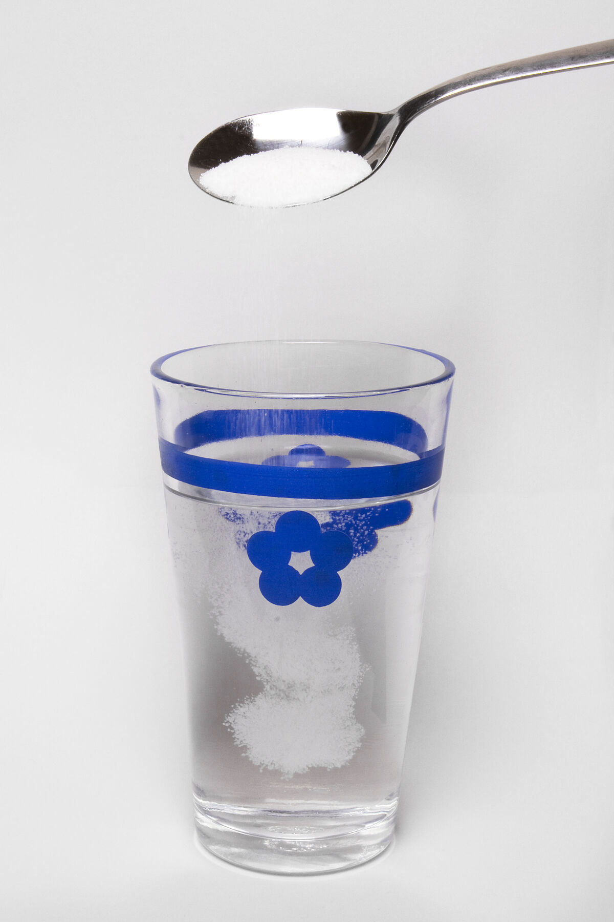 Combining sugar and water to prepare a sugar water solution. 