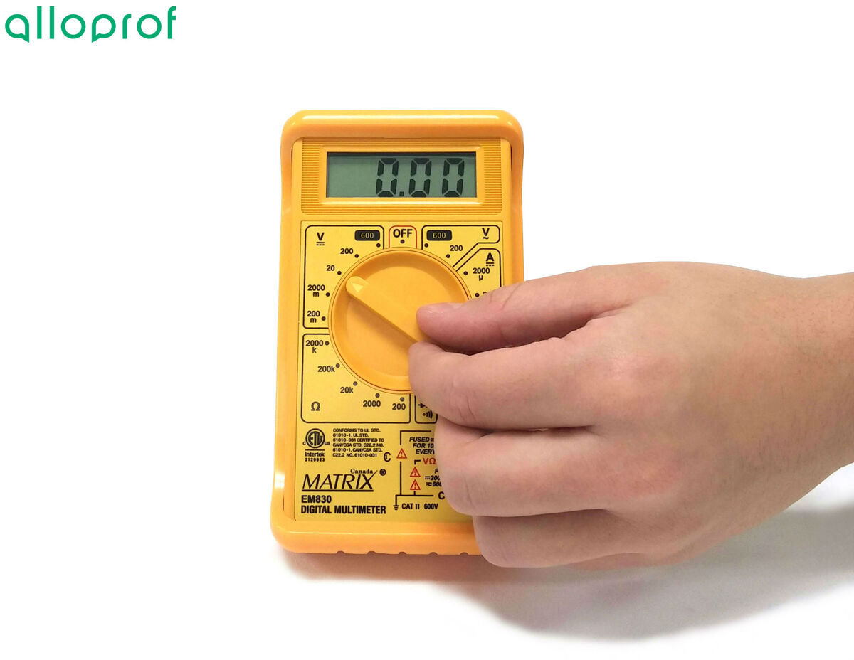 The multimeter is set to the 20 volts scale.