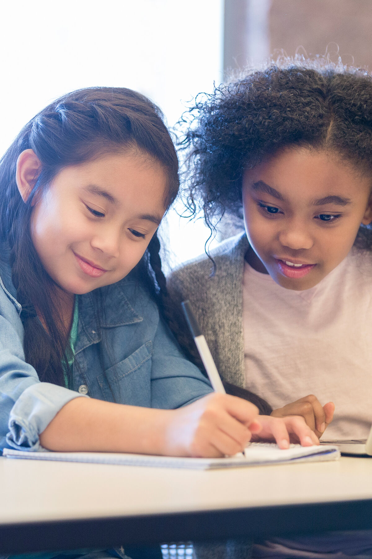 Two girls working together on a homework