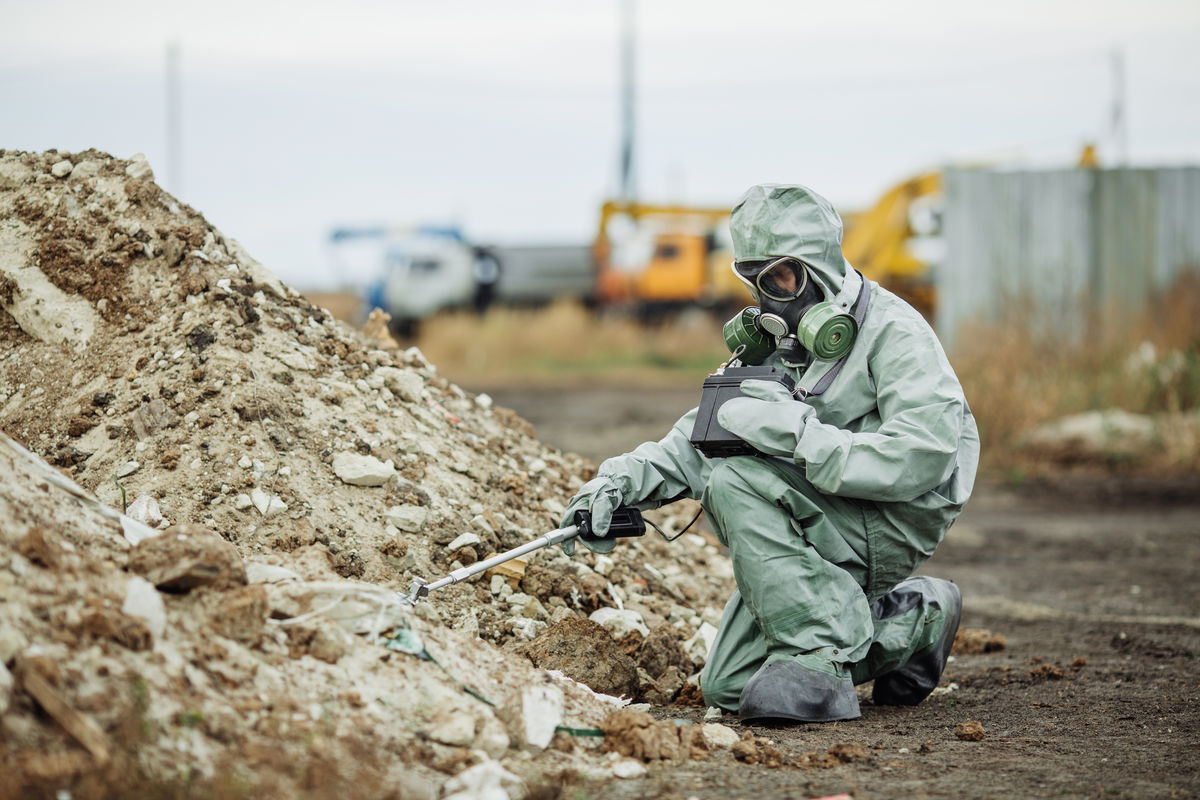 A scientist measures the level of radiation of a contaminated site.