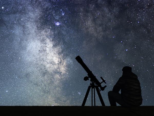 A person observing a starlit sky.