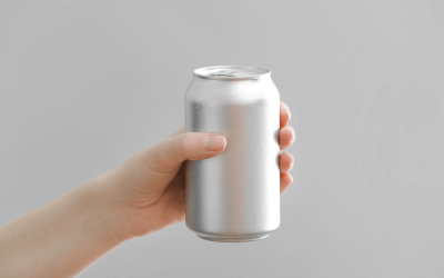 A hand holding an aluminum can.