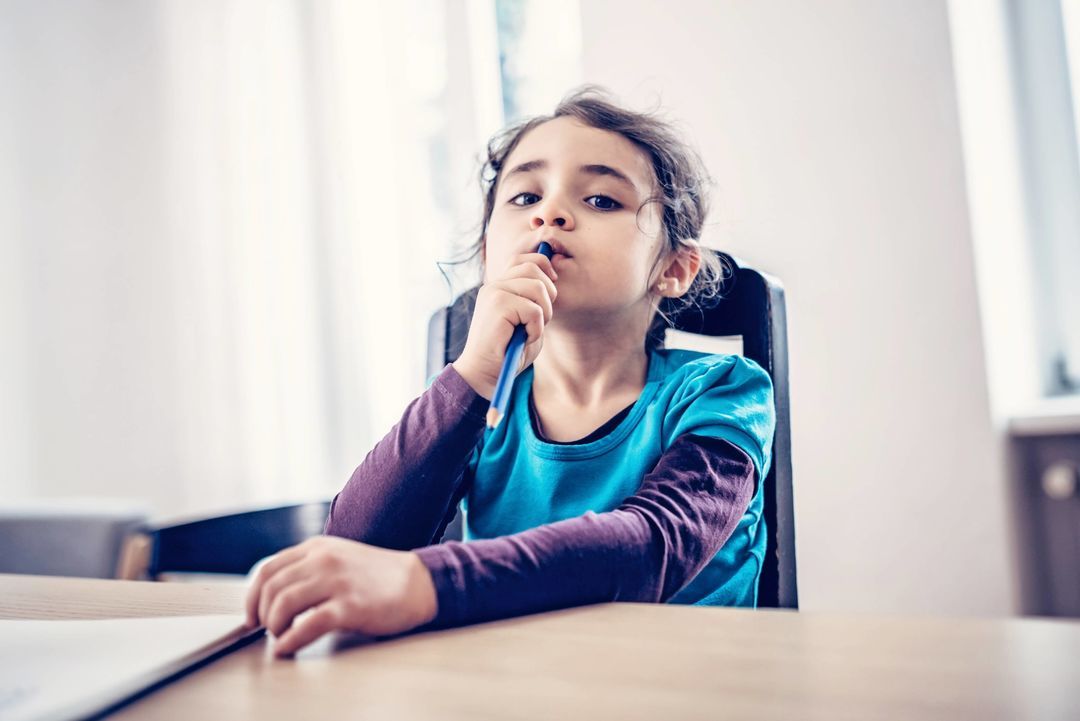 Young girl thinking with her fingers on her mouth