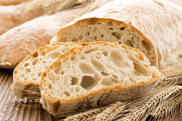 A photograph of the inside of a loaf of bread, showing the holes caused by gas bubbles.