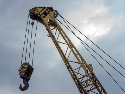 The wire rope of the crane passes over the movable pulleys on the hook and the fixed pulleys on the mast.