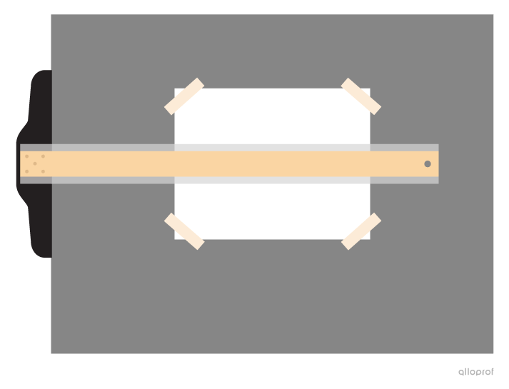 A photo of the sheet of white paper on the drawing board. The T-square is placed approximately in the middle of the sheet. Four pieces of tape are holding the sheet in place at the corners.