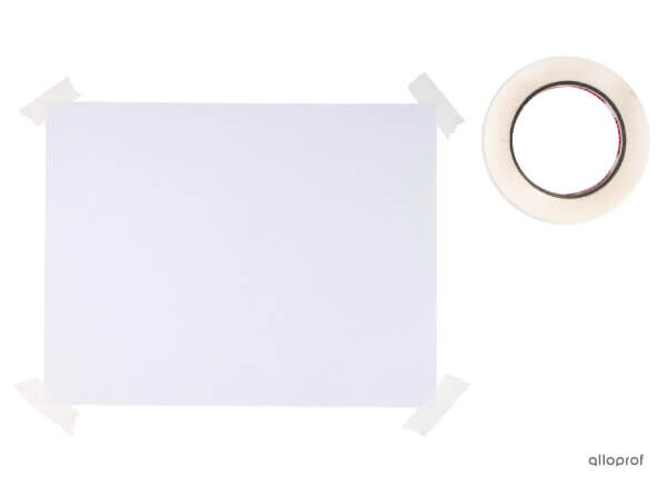 A photo of a sheet of paper taped to a drawing board with adhesive tape and a roll of tape.