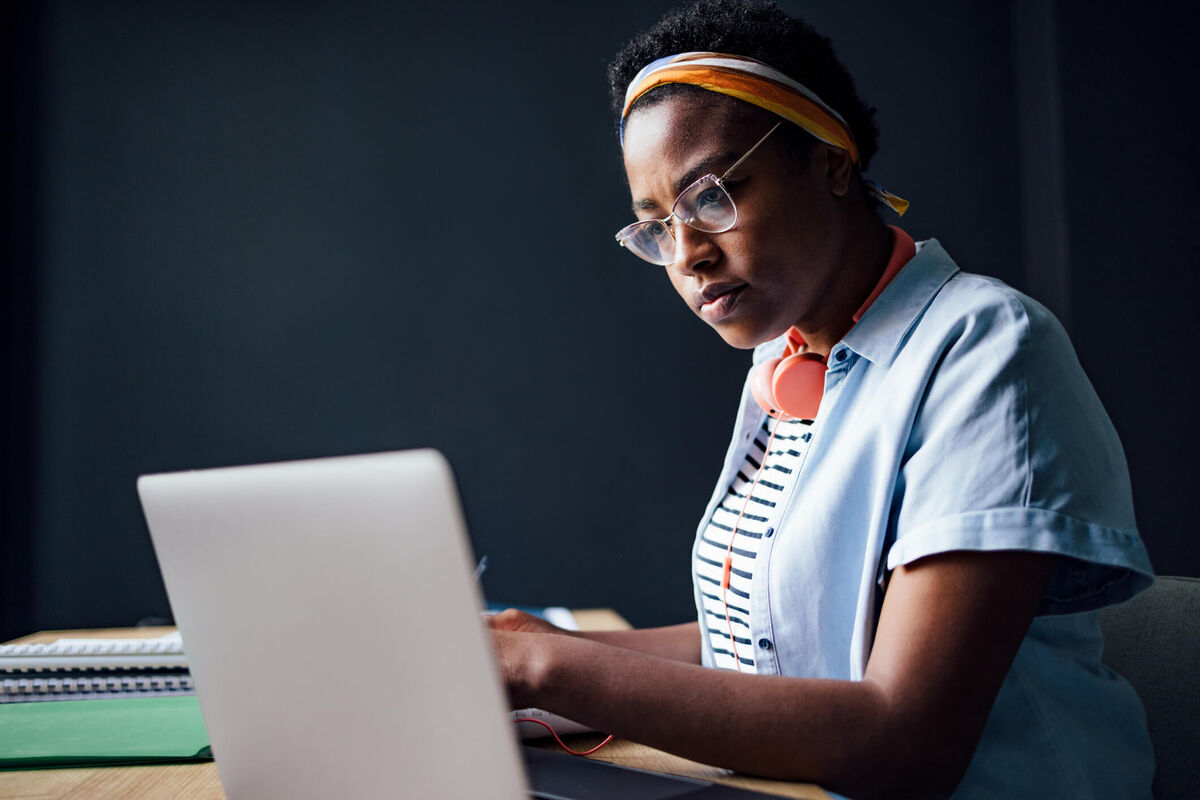 A teacher thinking in front of a computer.