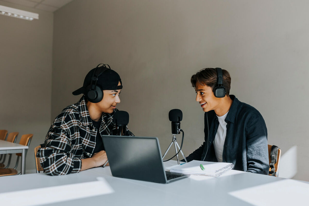 Two students recording their voice.