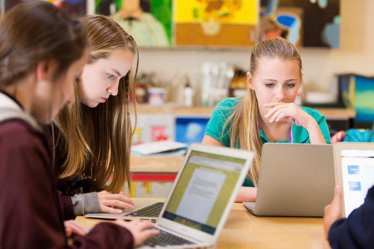 Students working in front of a computer.