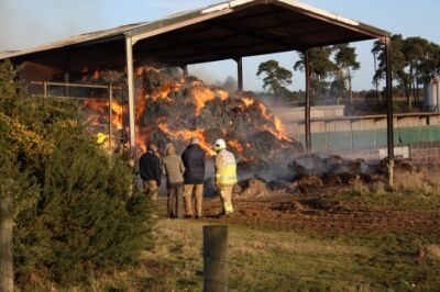 Hay on fire in a small barn.