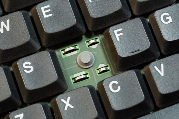 Image of a piece of rubber to which a computer keyboard key can be attached.