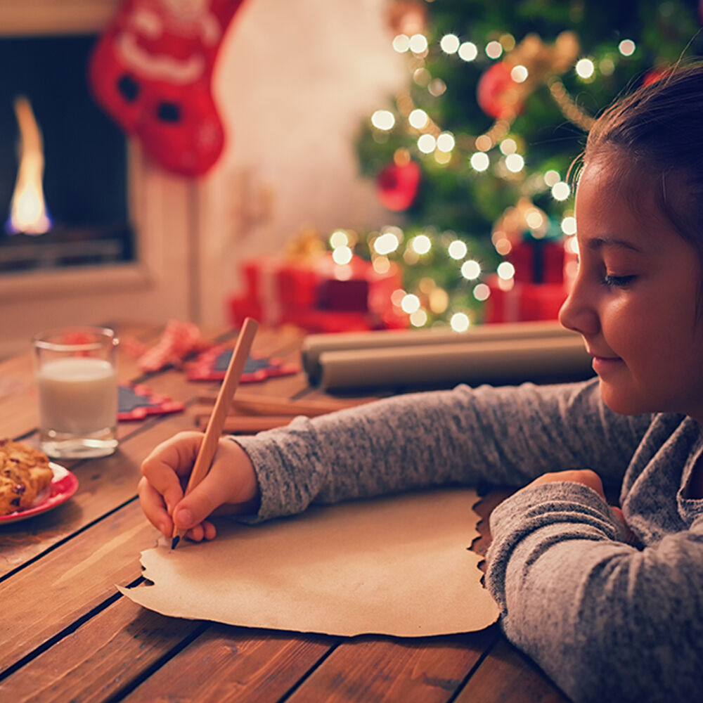 A girl writing a letter to Santa Claus.