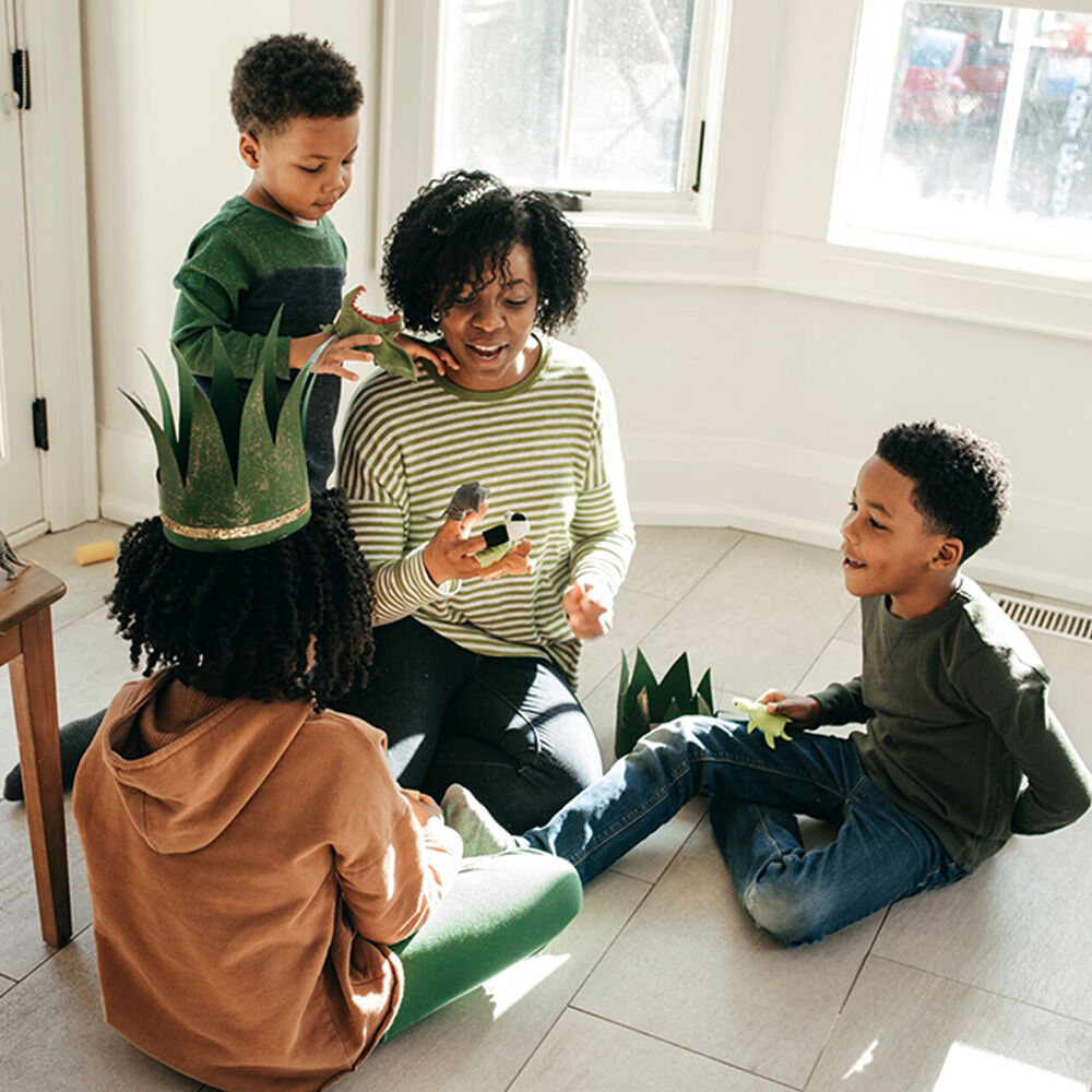 A mother playing with her three sons.
