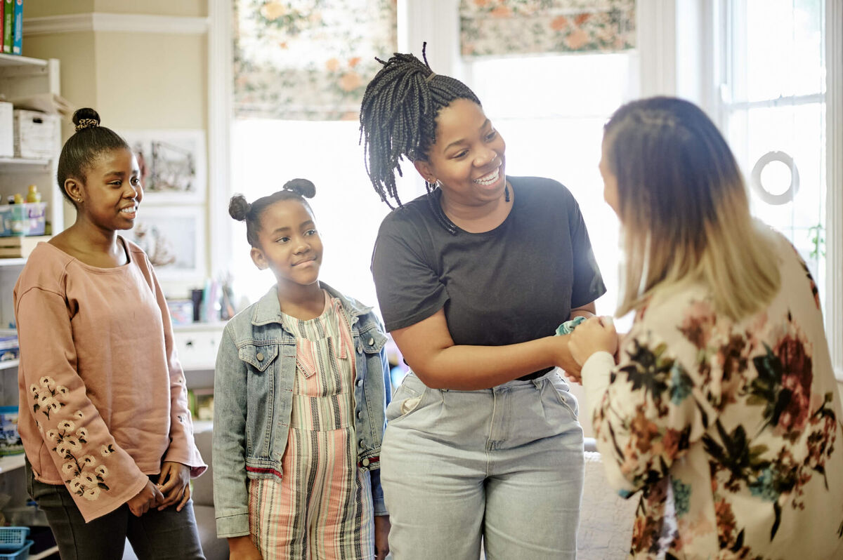 A teacher talking with her student's parents.