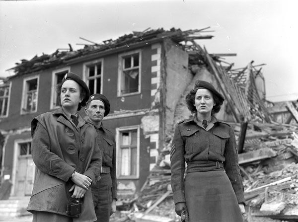 Photograph of two members of the Canadian Women’s Army Corps entering a German city.