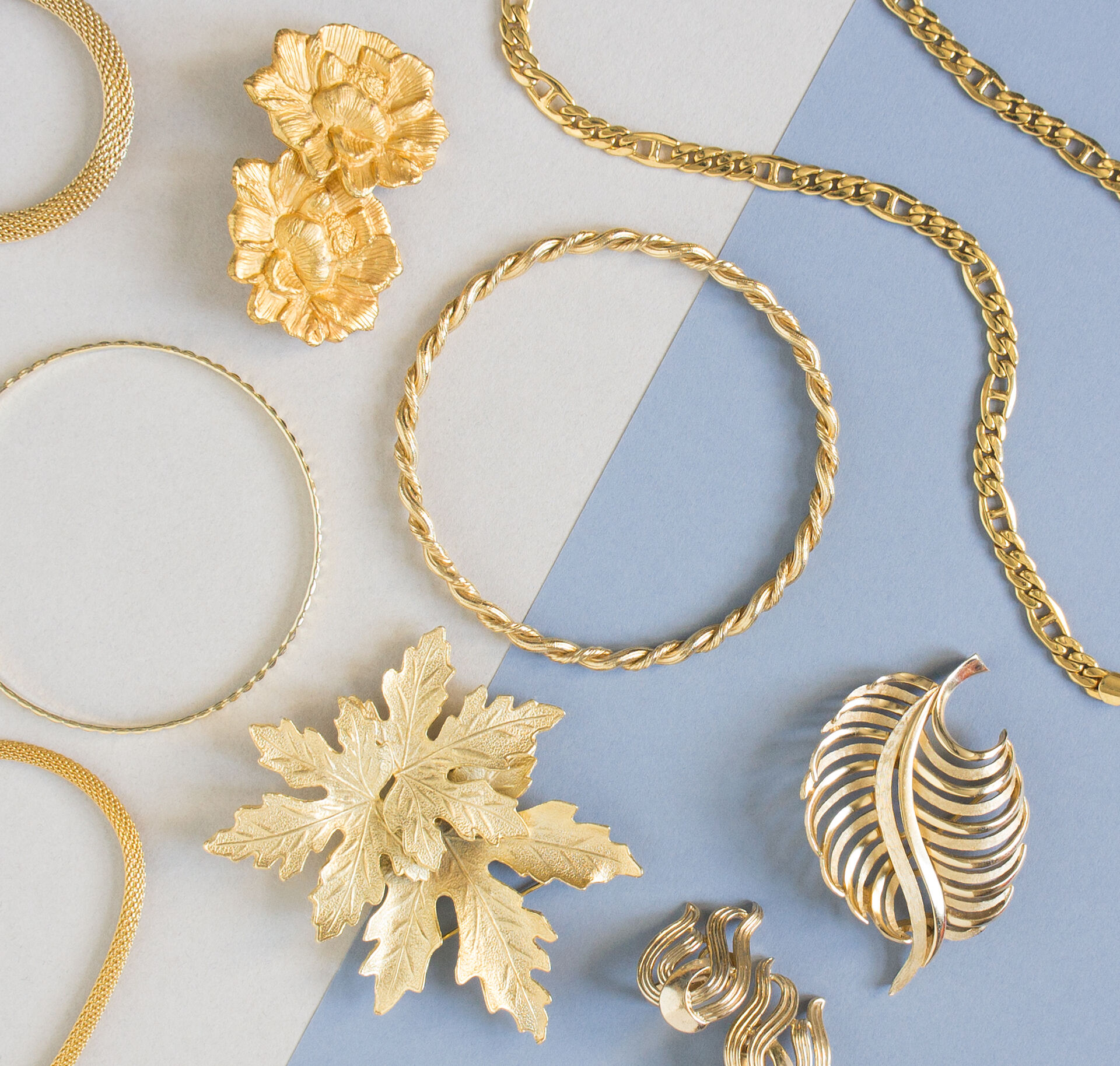 A gold brooch, bracelet, necklace, and earrings