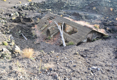 Photograph of a House Buried Under Lava.
