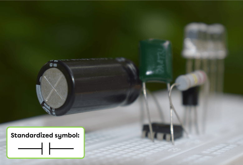 A photo of a capacitor and its standardized symbol.