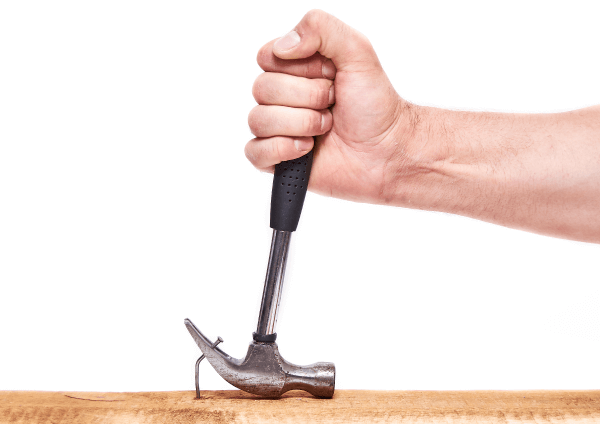 A nail driven into a piece of wood that can be removed with a hammer.