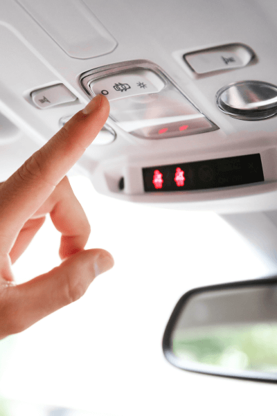 Switches near the rear-view mirror in a car.