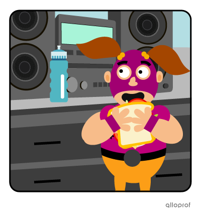 A wrestler in a mask eating a sandwich, with a stereo system in the background.